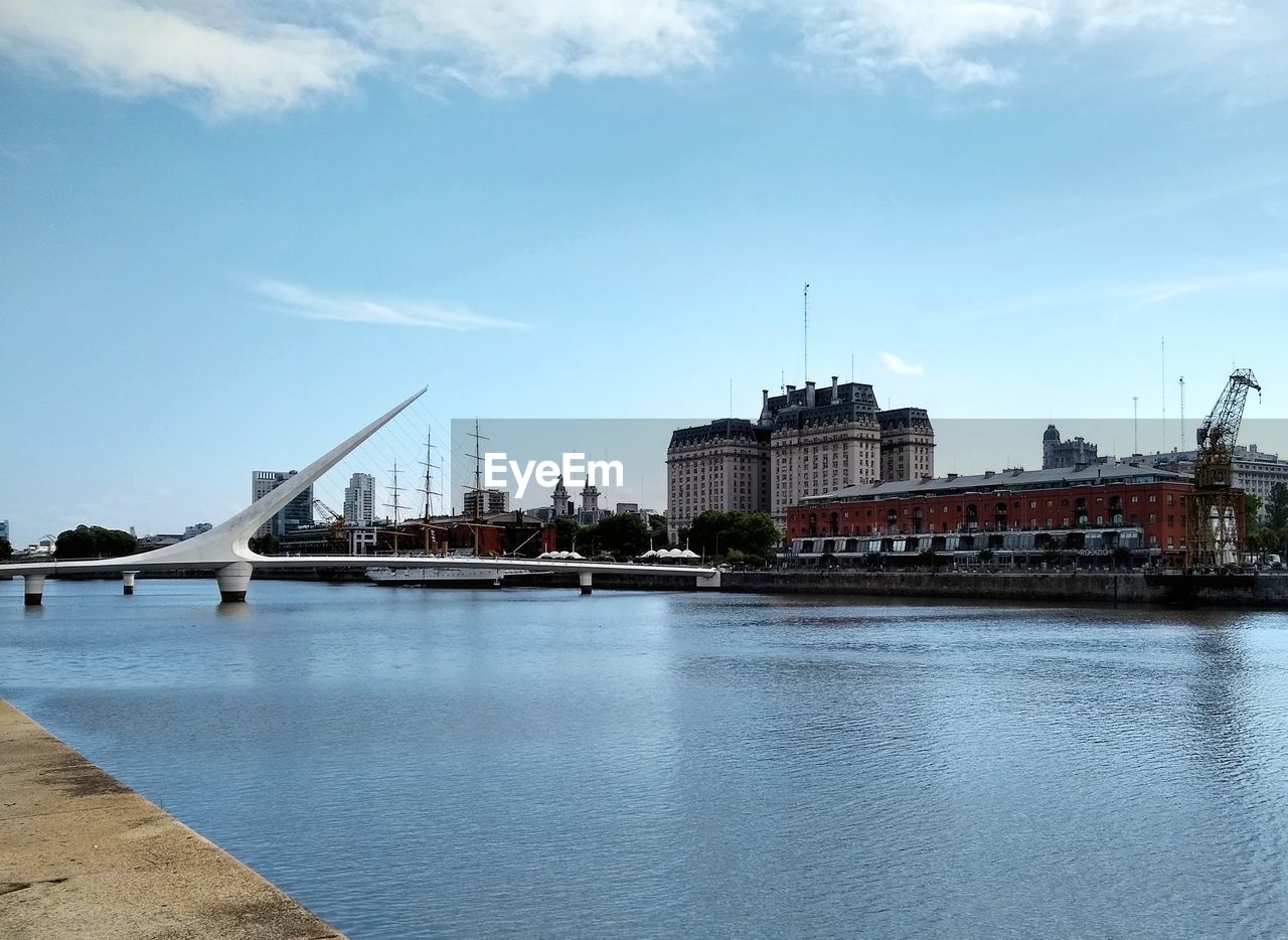 View of bridge over river against cloudy sky