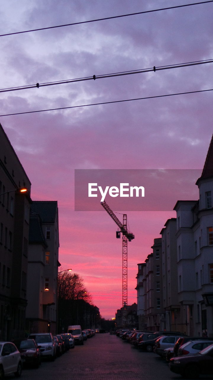 CARS PARKED ON STREET DURING SUNSET