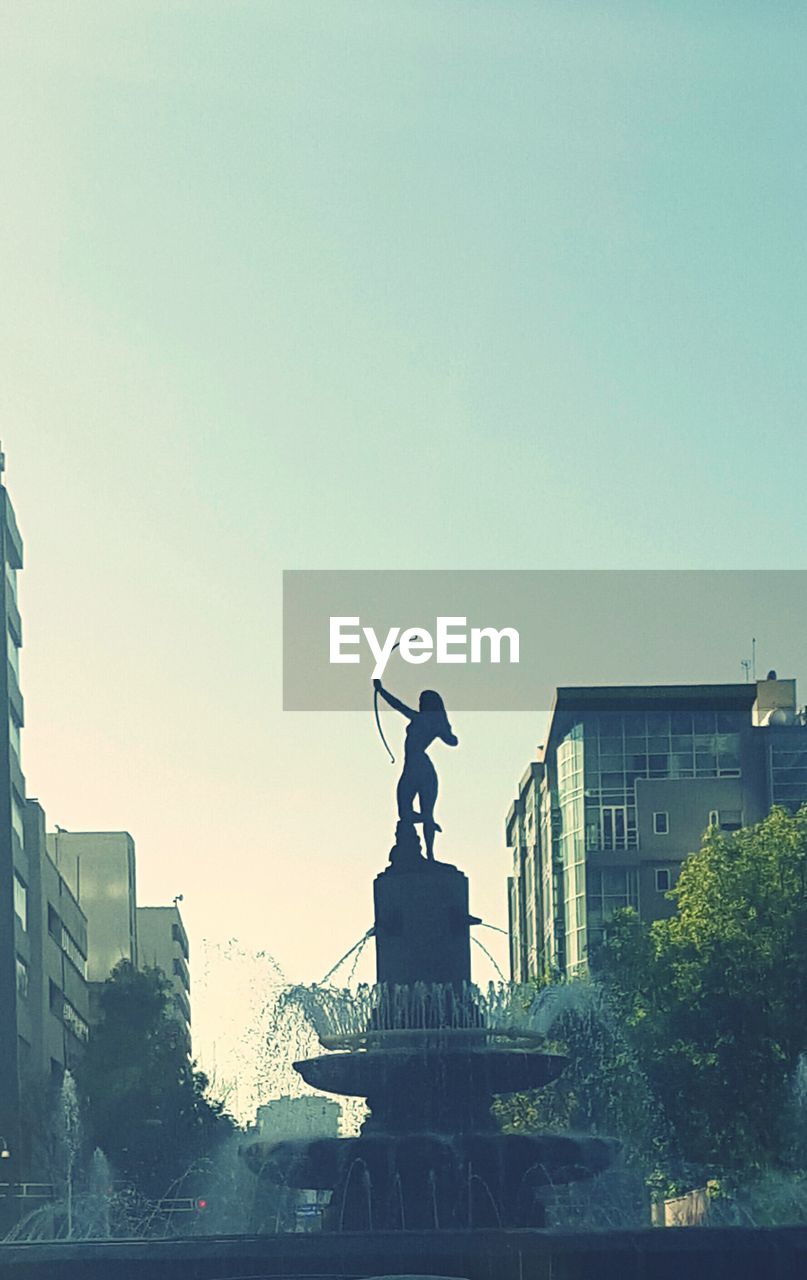 STATUE OF WOMAN AGAINST CLEAR SKY