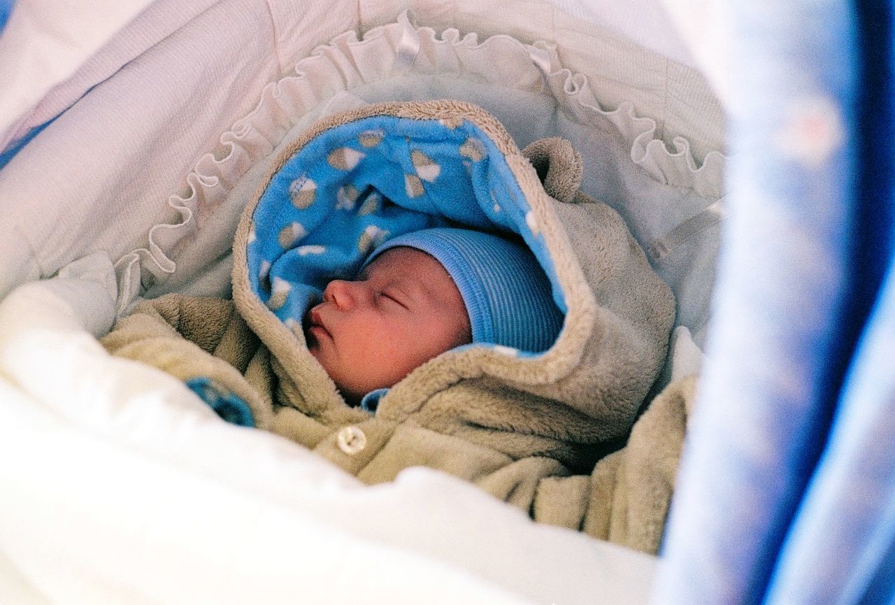 Baby boy sleeping in pram 