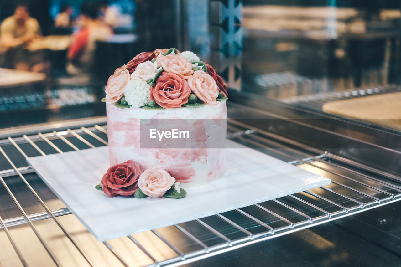 CLOSE-UP OF ROSE ON TABLE