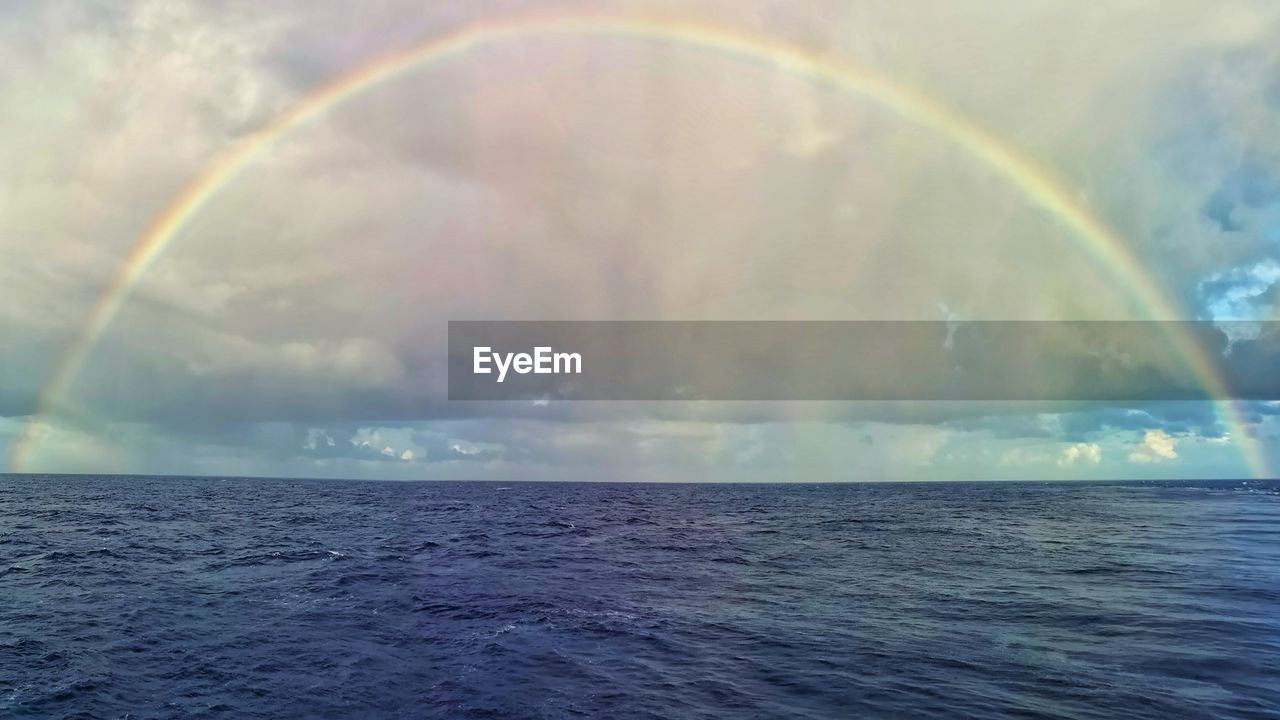 SCENIC VIEW OF RAINBOW OVER SEA