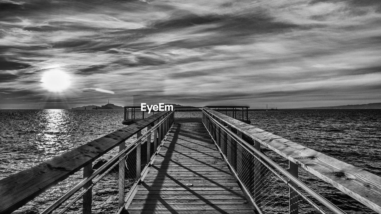 Pier over sea against sky