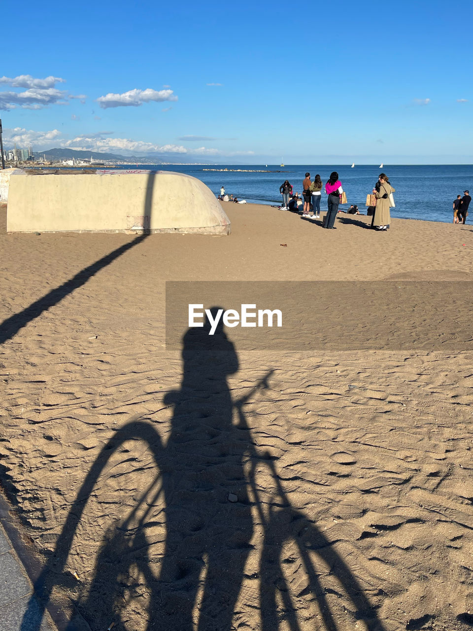 beach, land, shadow, sea, sand, sunlight, nature, water, sky, group of people, ocean, body of water, holiday, coast, leisure activity, sunny, vacation, trip, men, day, shore, horizon, scenics - nature, horizon over water, travel, lifestyles, beauty in nature, adult, women, outdoors, summer, travel destinations, large group of people, clear sky, tourism, blue, crowd, sports, motion, tourist
