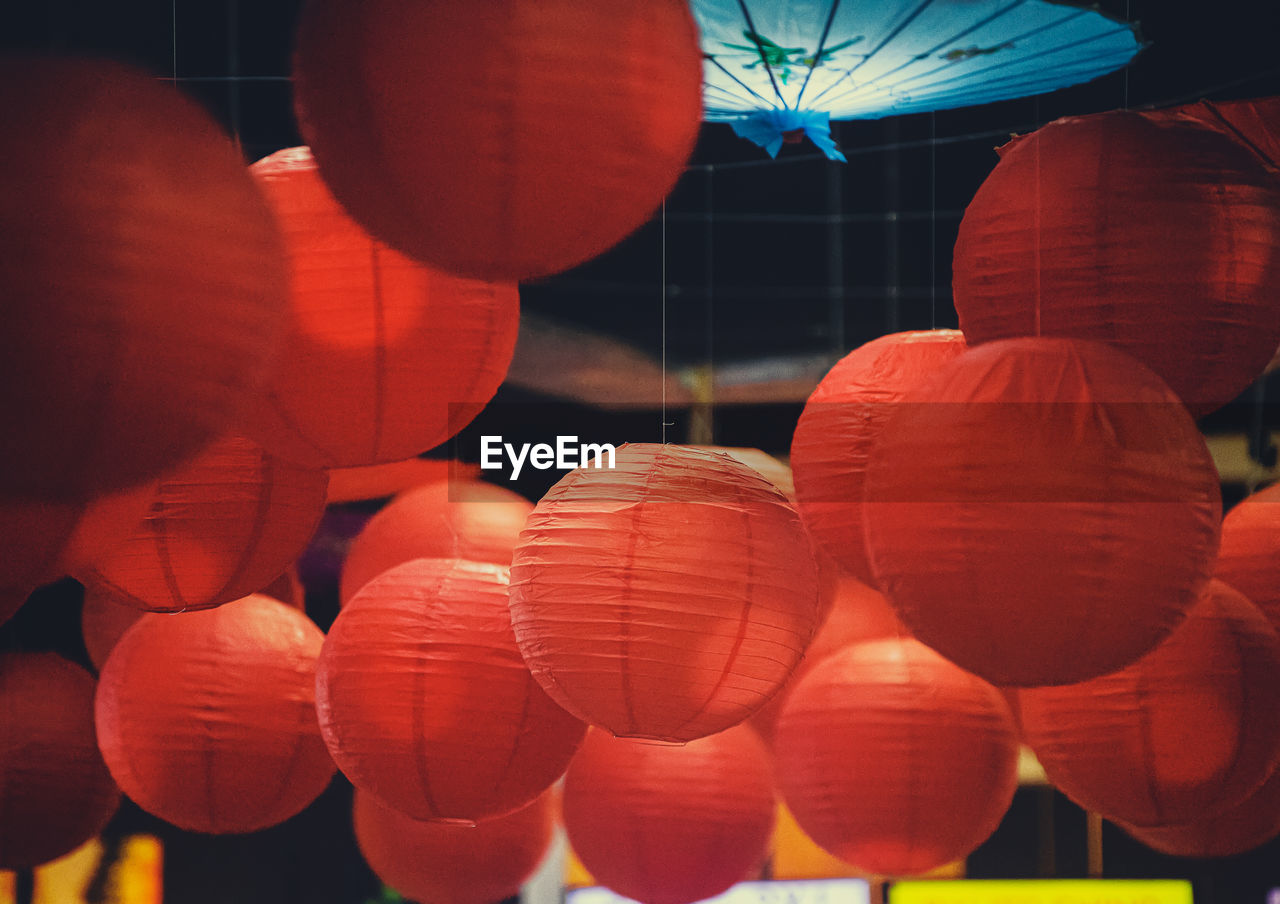 Low angle view of illuminated lanterns hanging at night