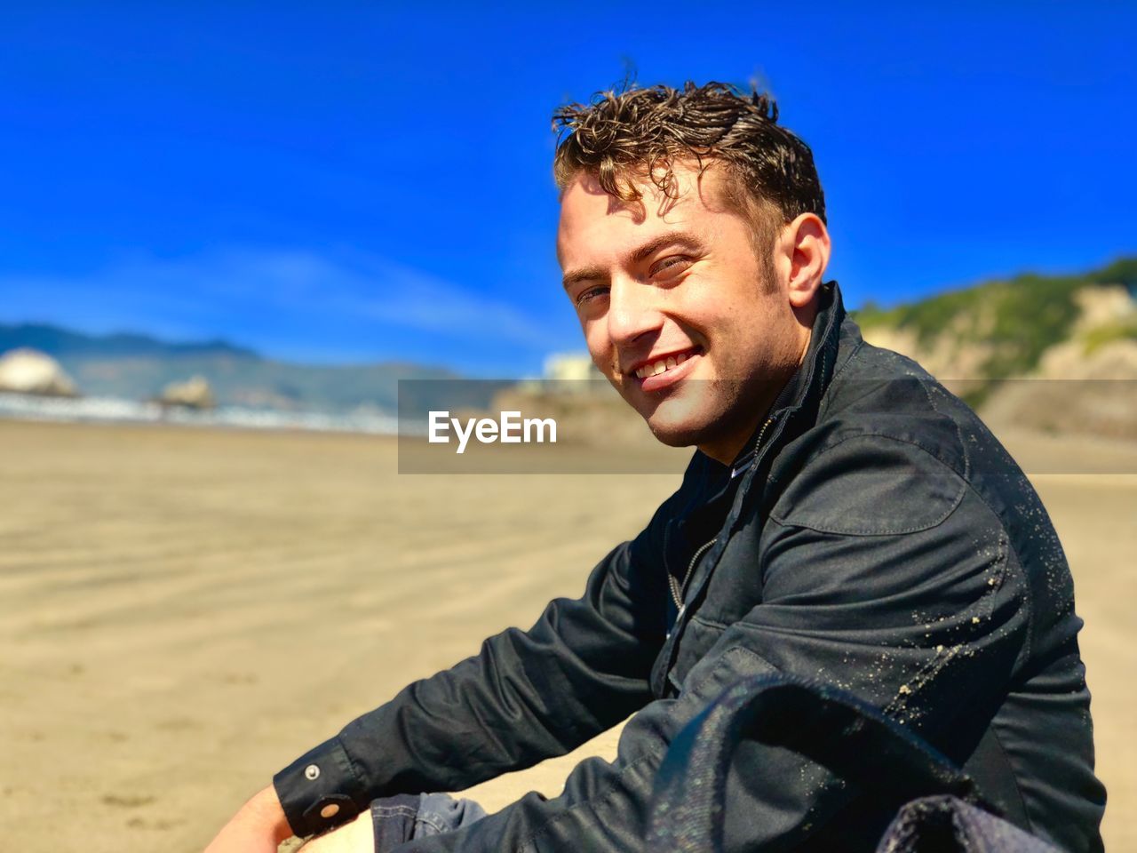 Portrait of smiling young man at beach