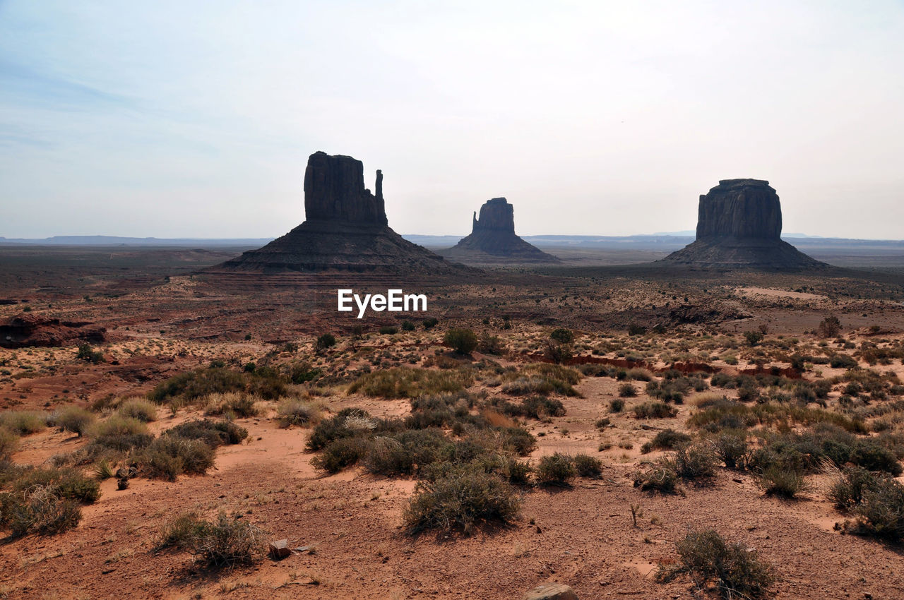 Barren landscape with rock formations in distance