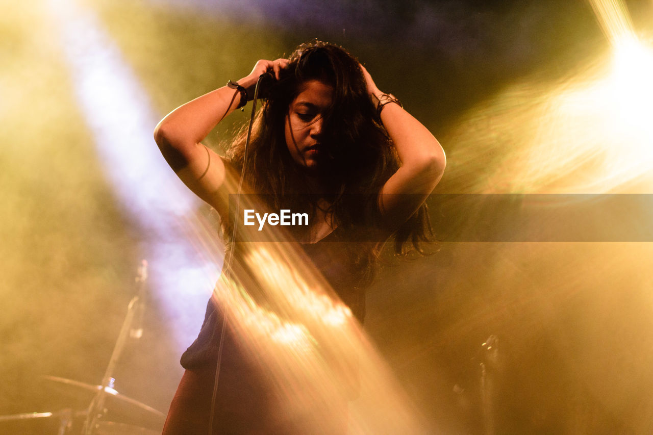 Woman by microphone at stage