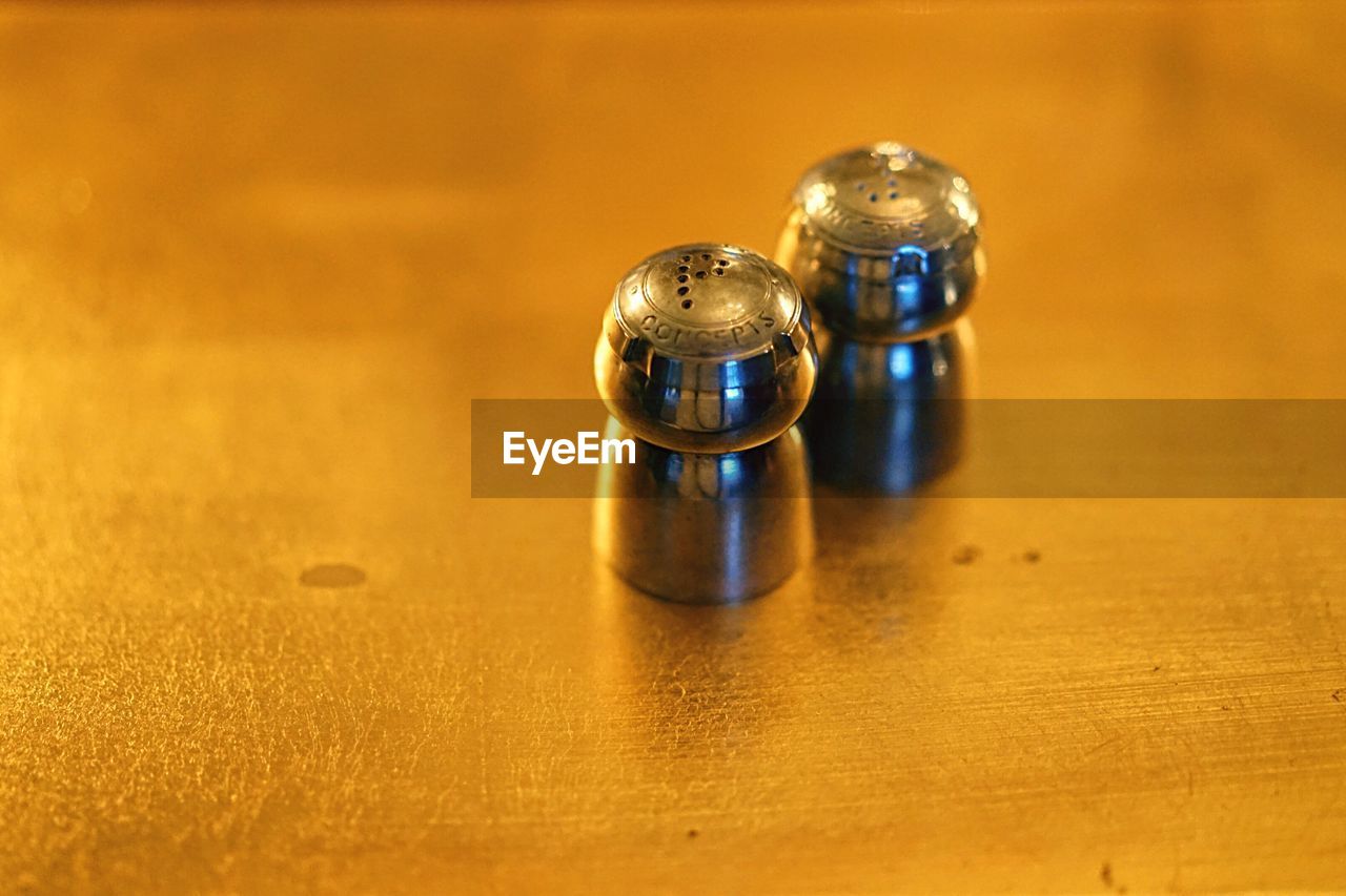 Close-up of salt and pepper shakers on table