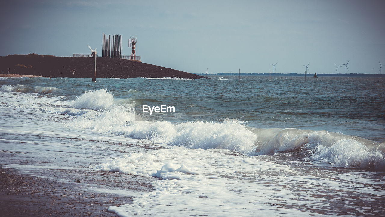 WAVES BREAKING AGAINST SEA