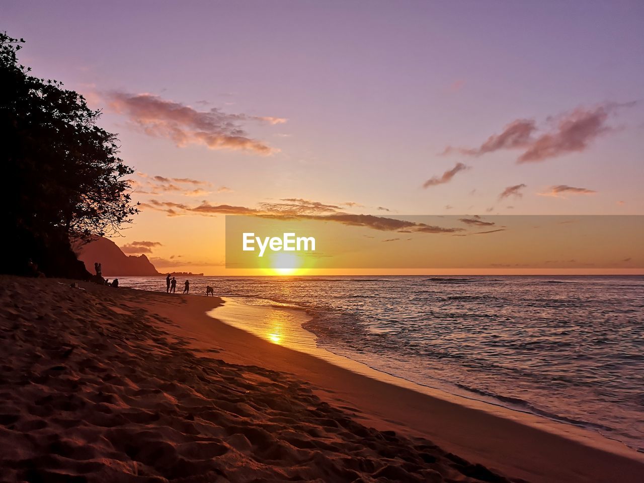 Scenic view of beach against sky during sunset