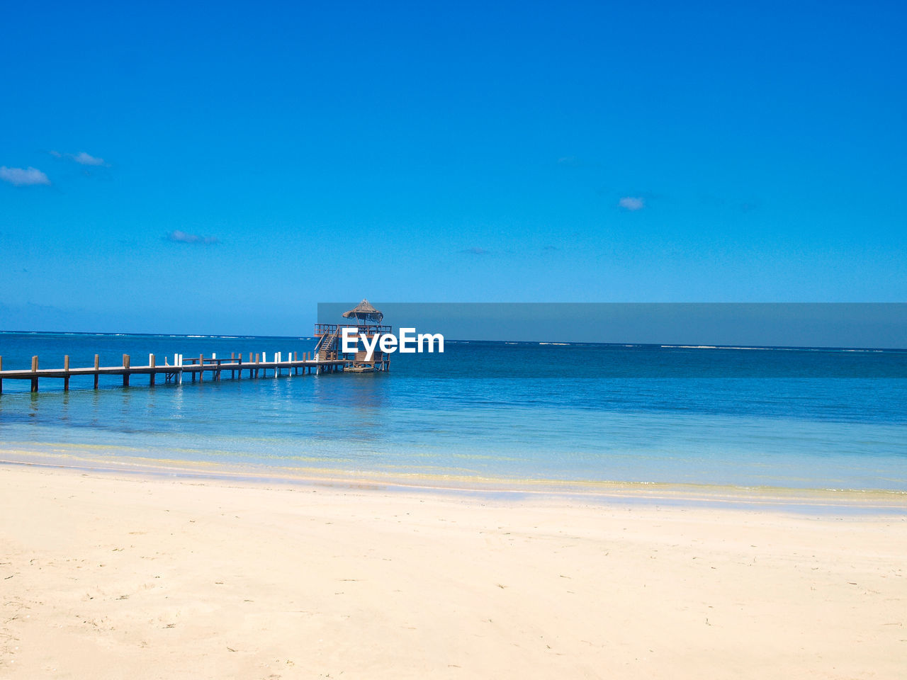 Scenic view of sea against blue sky