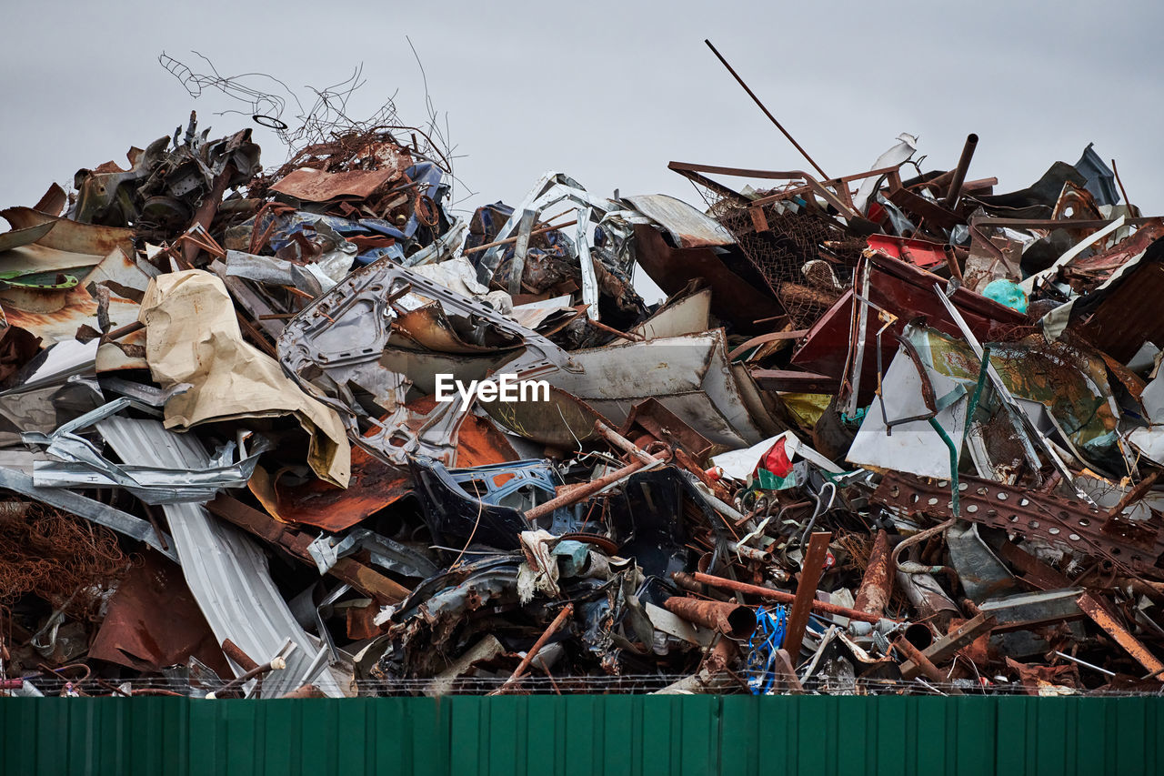 Metal scrap waste dump for recycling. city fenced landfill. iron garbage and trash.