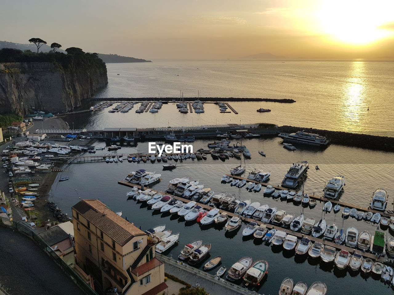 HIGH ANGLE VIEW OF BOATS MOORED AT HARBOR