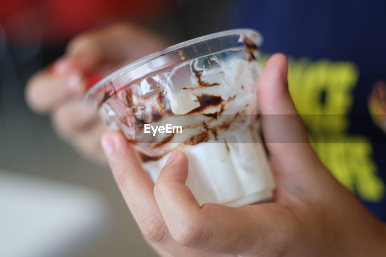 Close-up of hand holding ice cream