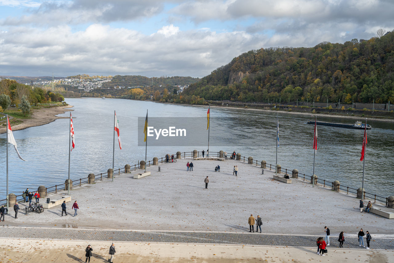 water, body of water, sea, shore, beach, coast, large group of people, group of people, crowd, land, sky, nature, cloud, mountain, holiday, vacation, travel, travel destinations, trip, bay, tourism, leisure activity, architecture, day, outdoors, scenics - nature, high angle view, coastline, lifestyles, tourist, transportation, men, environment, sand, beauty in nature, walkway