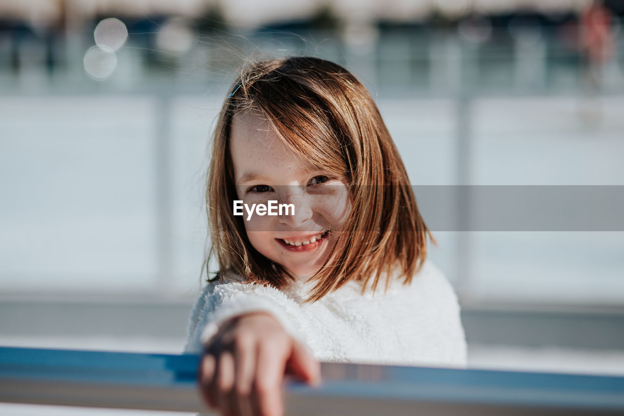 Center portrait of a young girl outside on a sunny winter day