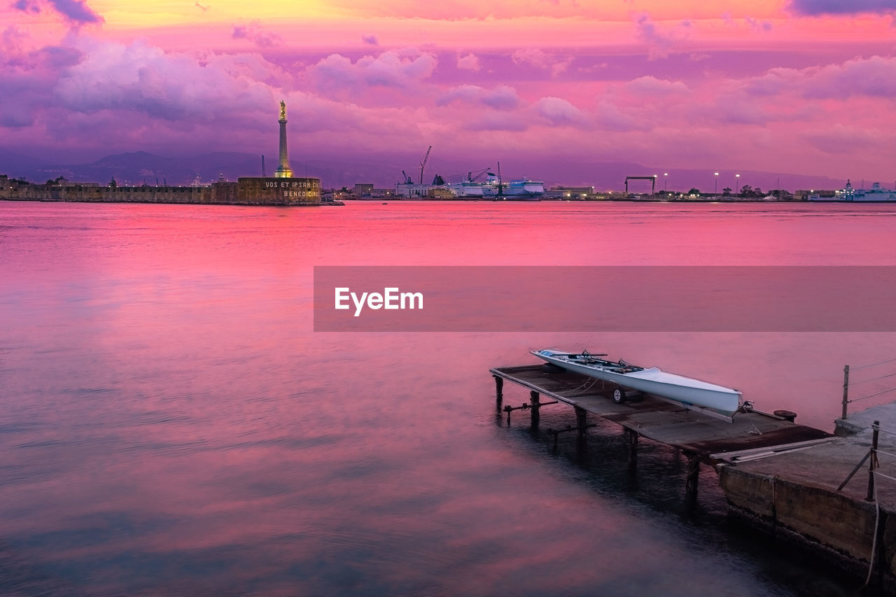 PIER AT SEA AGAINST SKY AT SUNSET