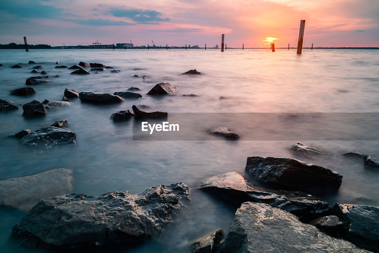 Scenic view of sea against sky at sunset