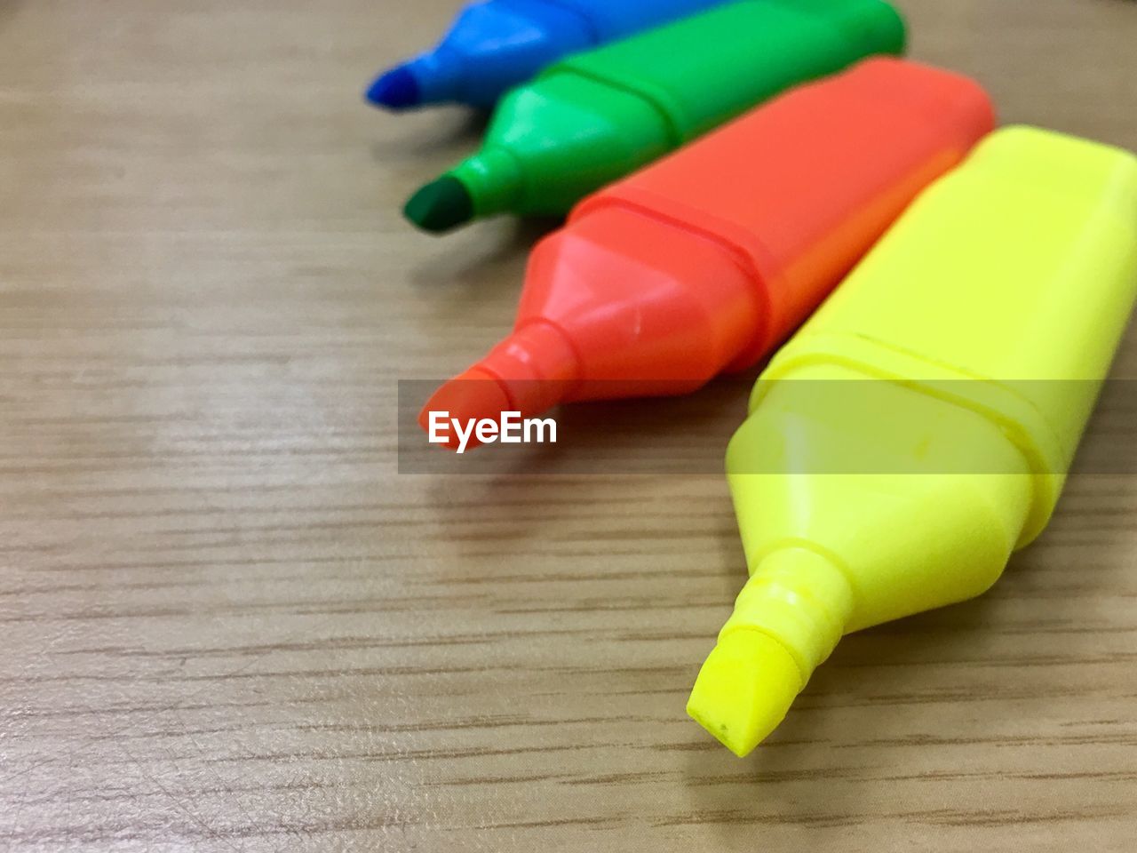 Close-up of colorful felt tip pens on wooden table