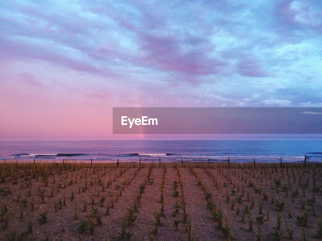 Scenic view of beach against sky during sunset