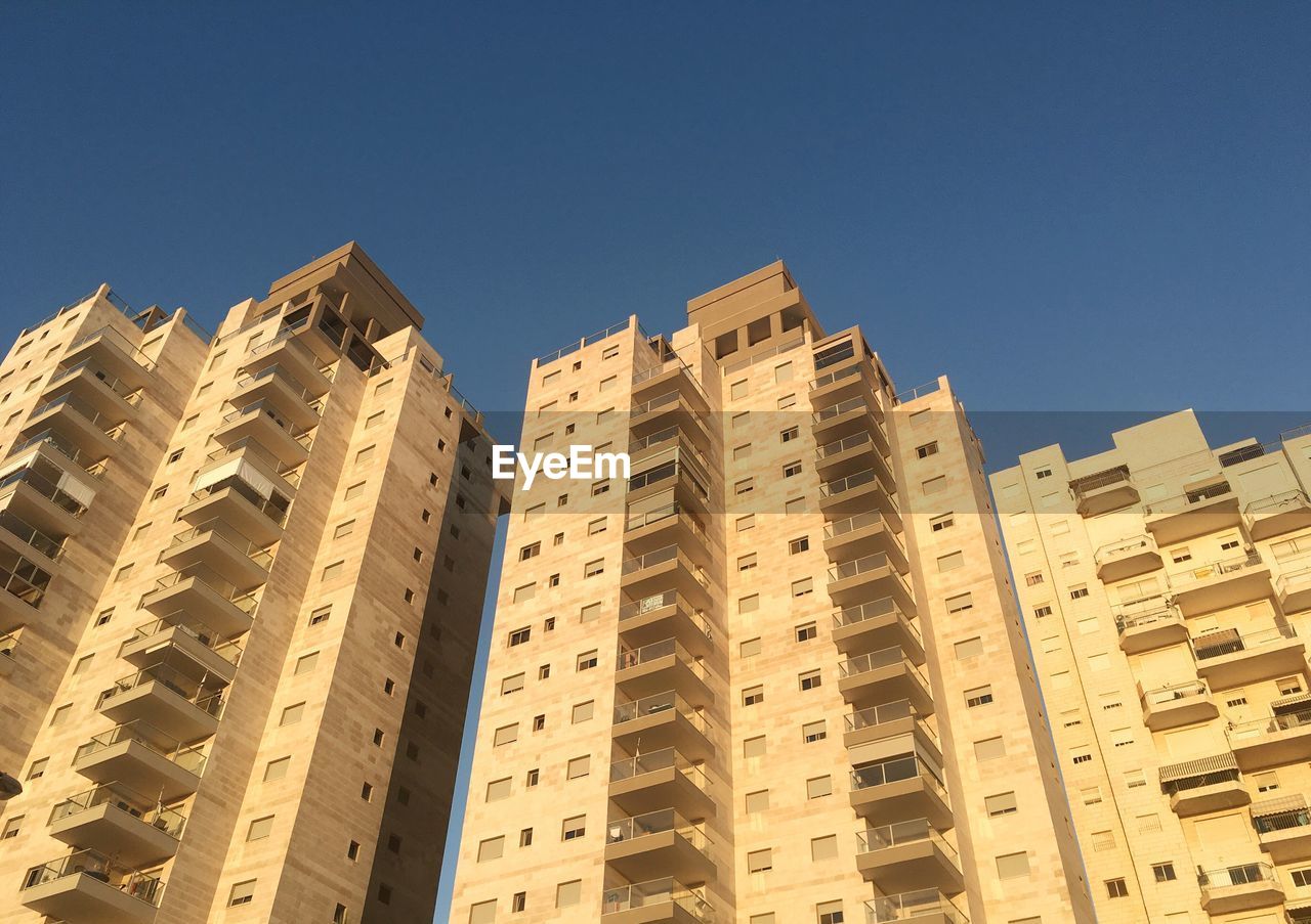 Low angle view of skyscrapers against clear sky