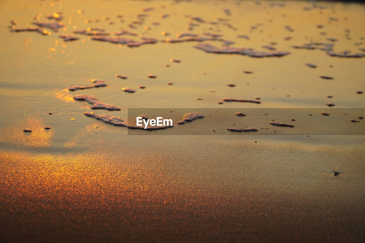 High angle view of wet sand on beach