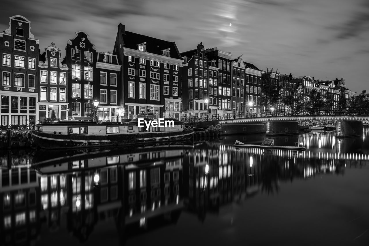 Bridge over river in city at night