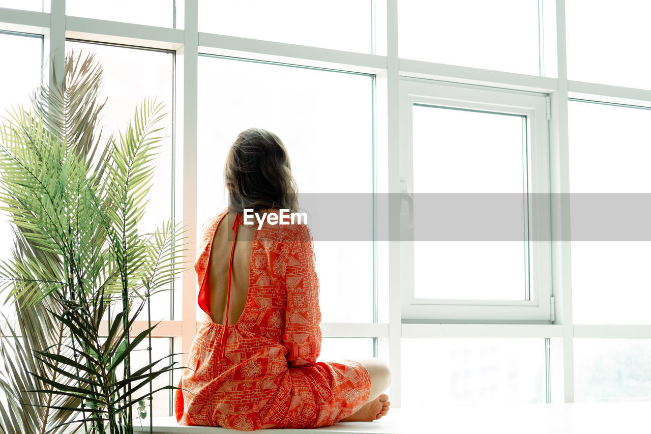 Yoga at home. keep calm. attractive young woman sitting on lotus position on floor with eyes closed.