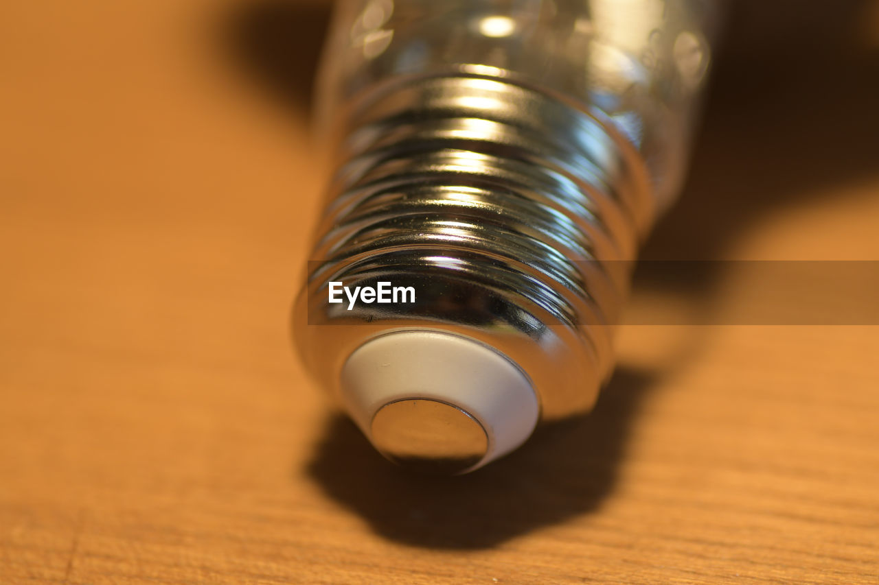 Close-up of light bulb on table