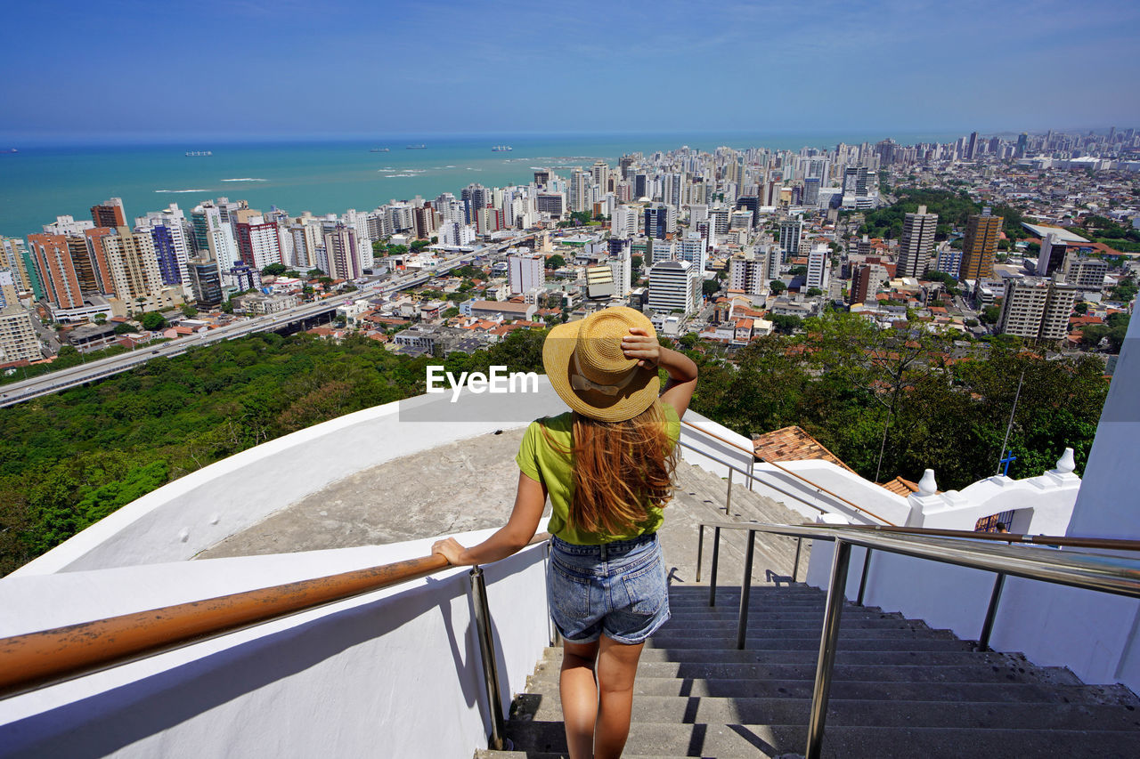 Beautiful fashion girl enjoying view of the vitoria metropolitan region, espirito santo, brazil.