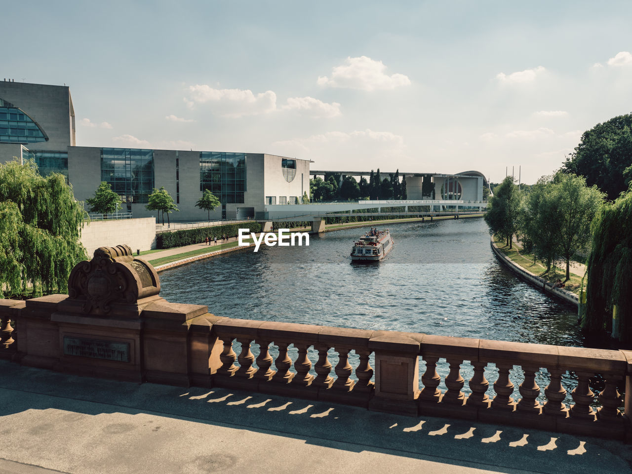 Bridge over river against sky in city