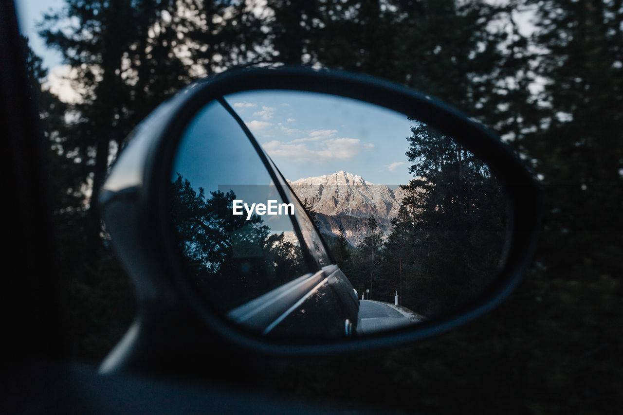 Reflection of mountain in side-view mirror