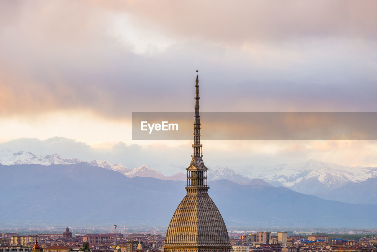 Spire against mountain