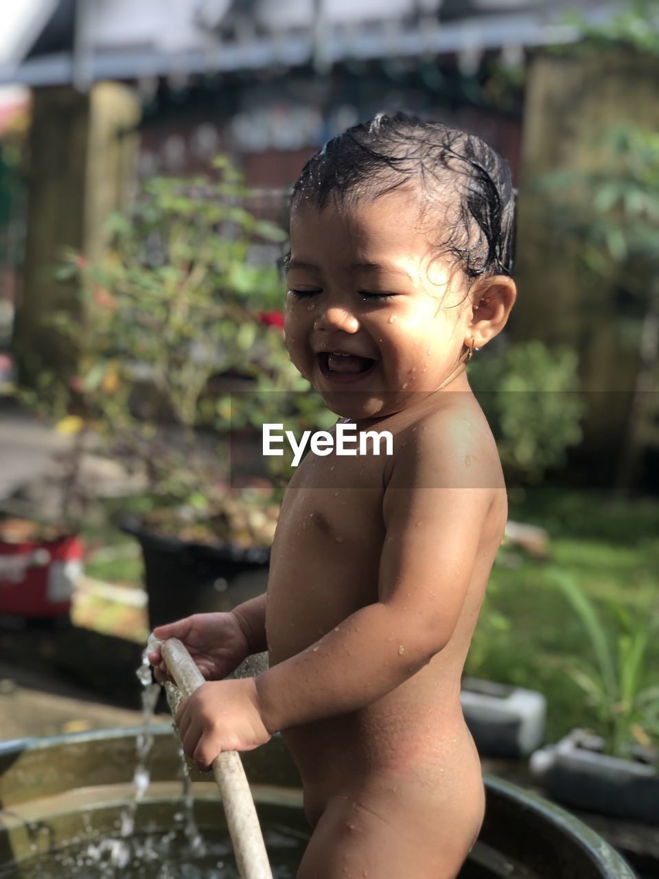 Full length of shirtless boy in water