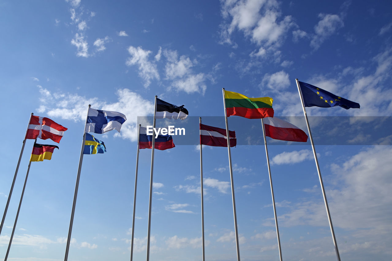 Low angle view of flags against sky