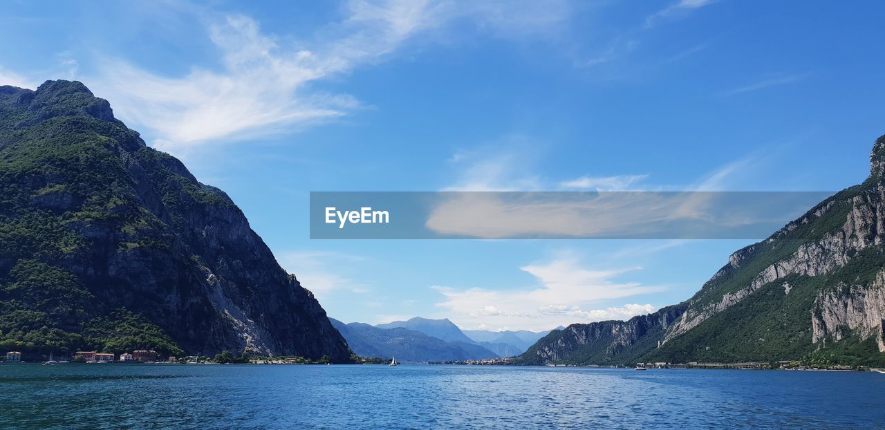 Scenic view of sea and mountains against sky