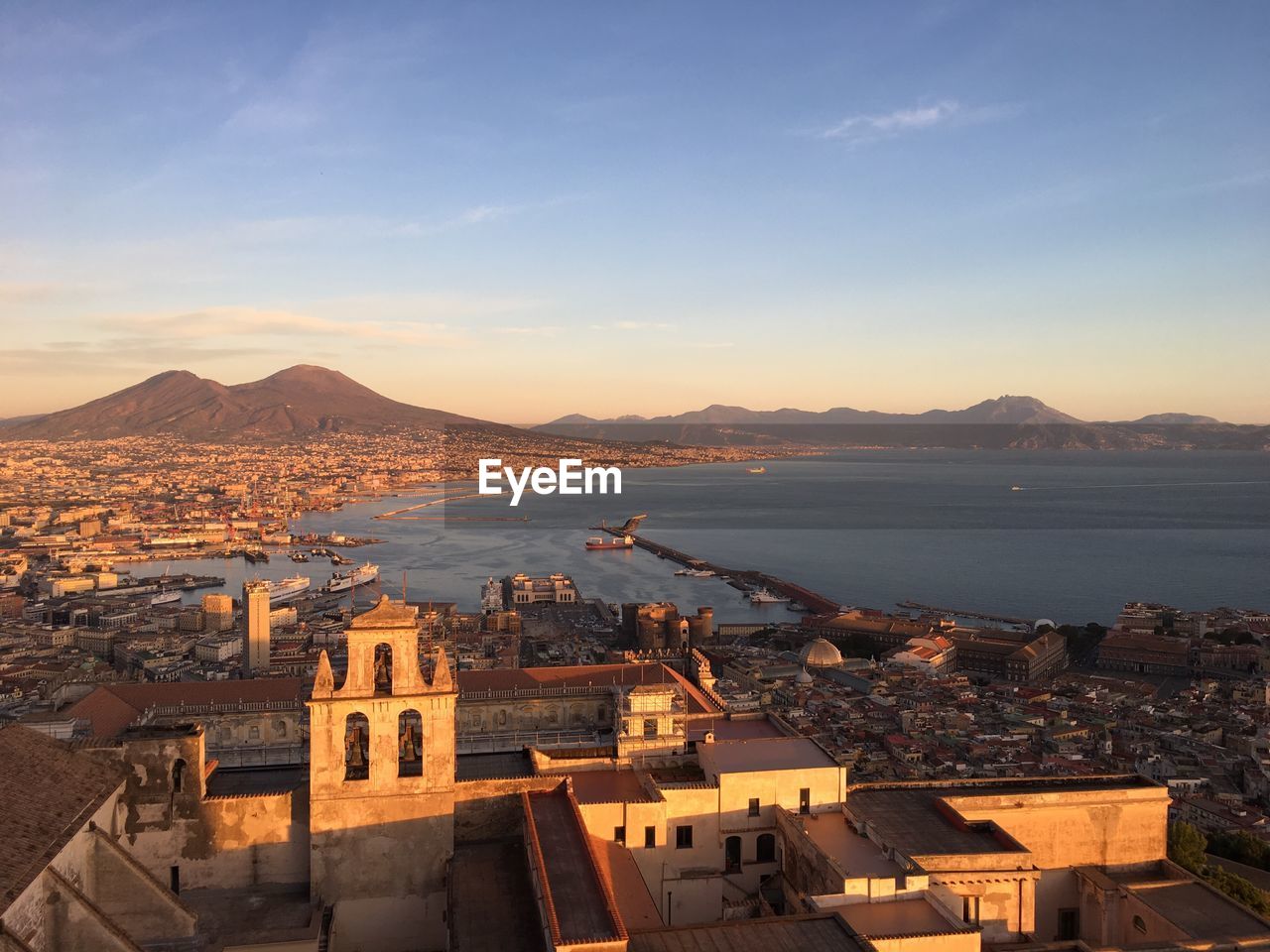 High angle view of town by sea against sky