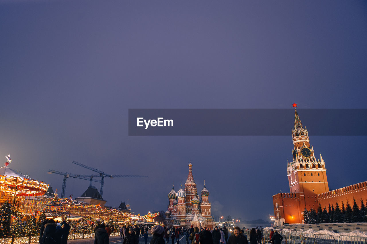 ILLUMINATED BUILDINGS AGAINST SKY IN CITY