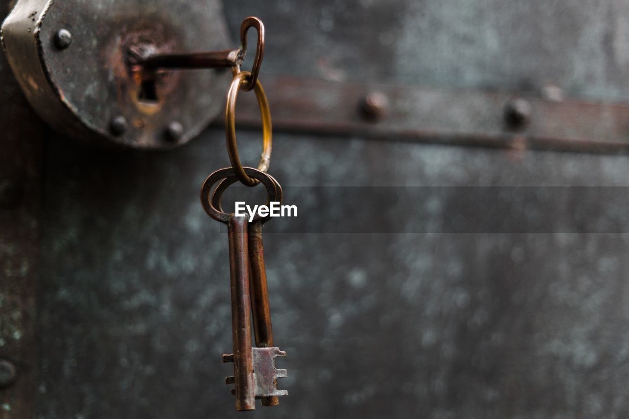 Close-up of key hanging in door