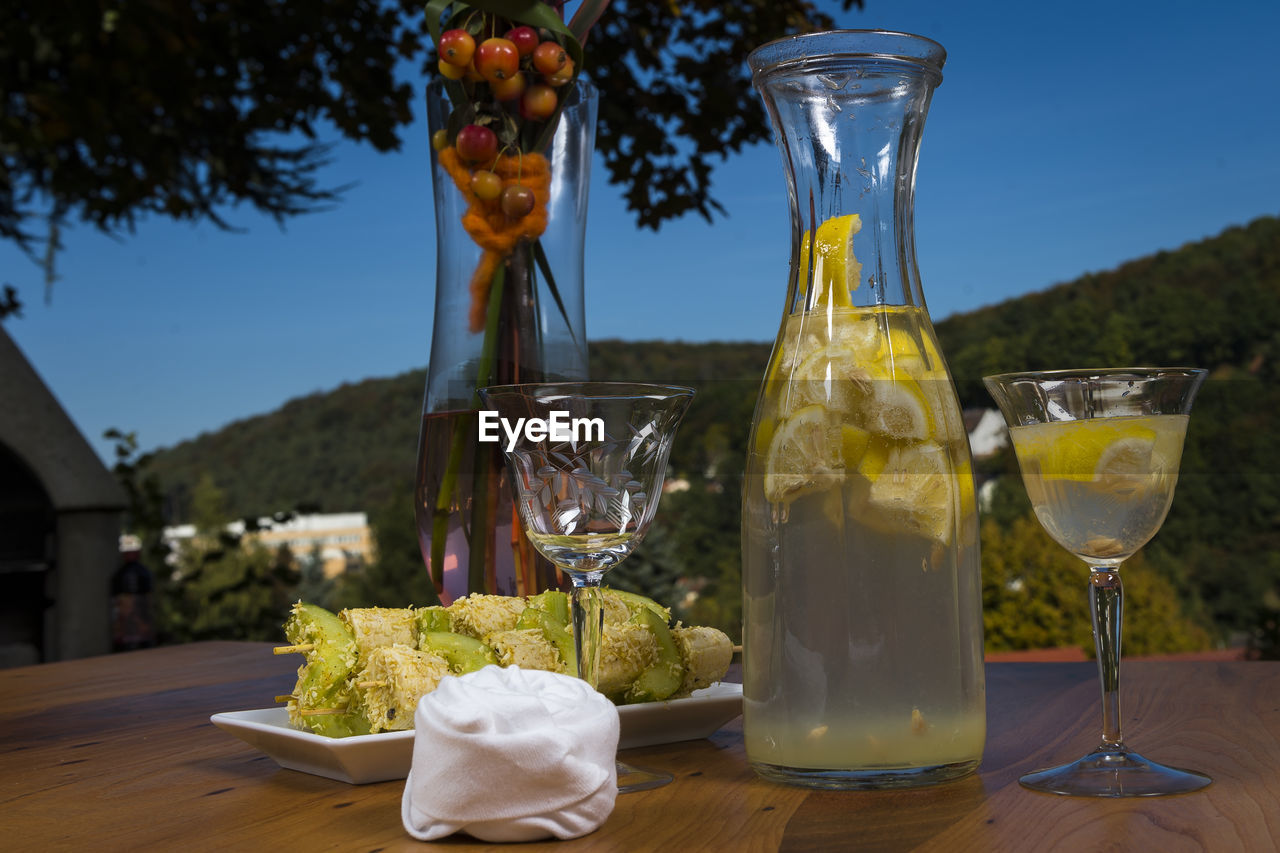 Close-up of food and drink on table at dusk