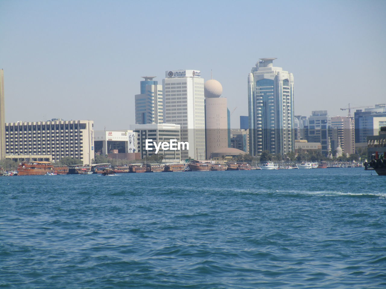 MODERN BUILDINGS BY SEA AGAINST CLEAR SKY