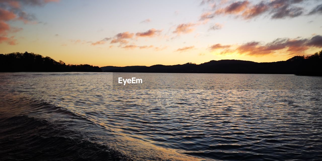 Scenic view of lake against sky during sunset