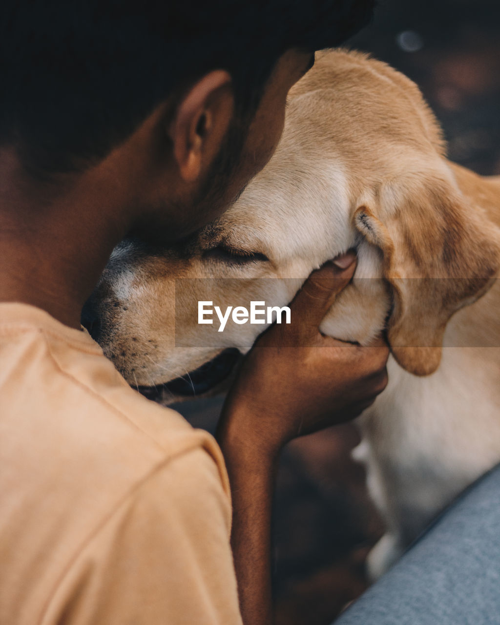 Close-up of man embracing with dog outdoors