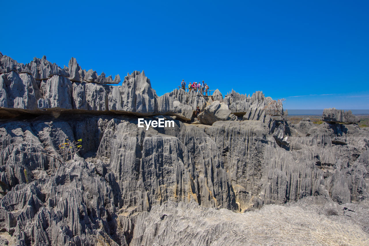 Panoramic view of rocks against clear blue sky