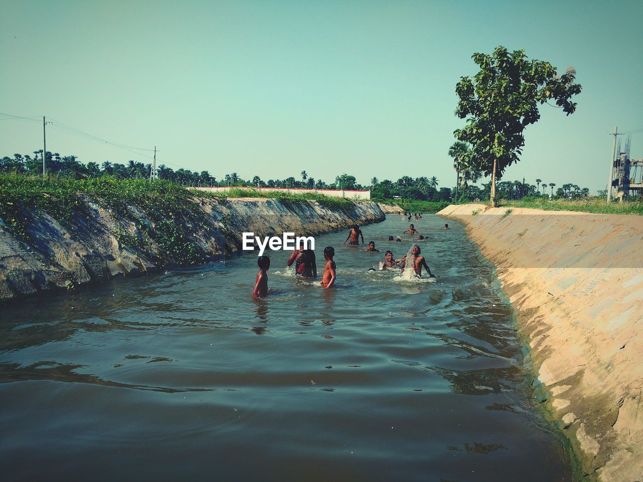 PEOPLE ON SHORE AGAINST SKY