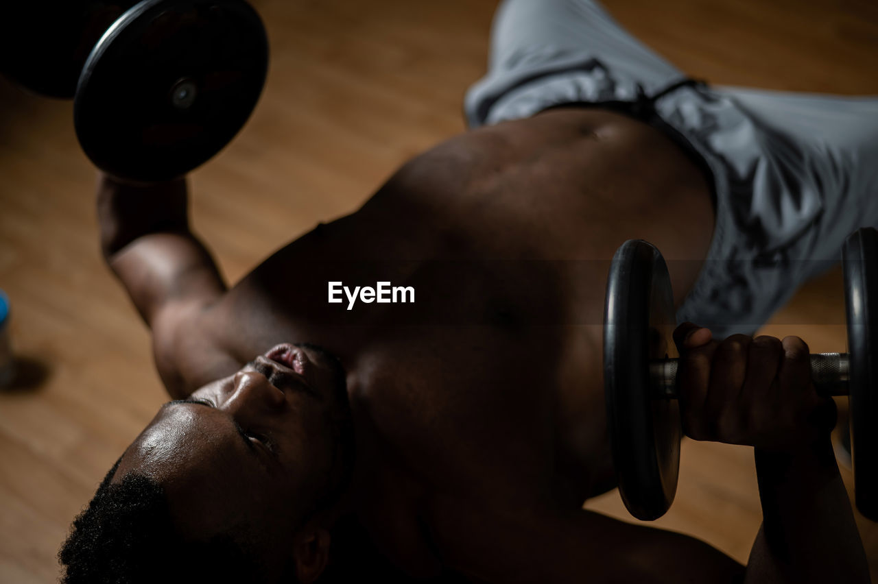 Midsection of man exercising in gym