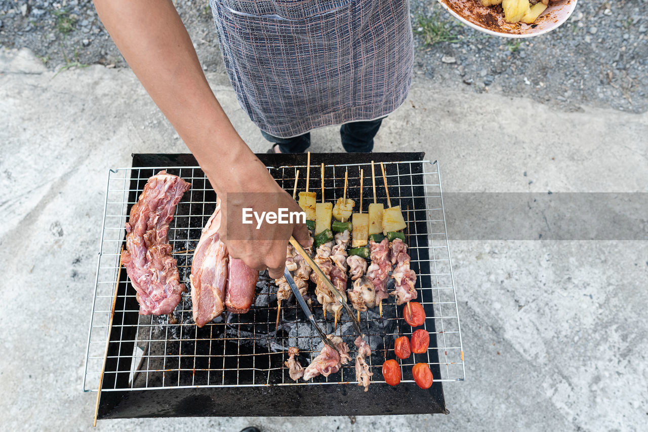 High angle view of people on barbecue grill