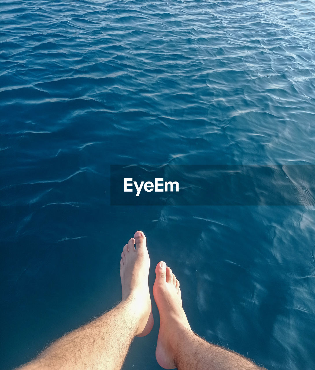 water, low section, human leg, personal perspective, sea, barefoot, nature, one person, lifestyles, leisure activity, adult, human foot, holiday, ocean, vacation, trip, relaxation, day, high angle view, limb, human limb, men, outdoors, rippled, sunlight, summer, women, swimming, beauty in nature, blue, tranquility, underwater, travel