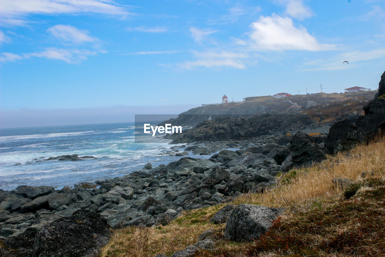 sea, sky, water, land, beach, rock, cliff, coast, shore, nature, scenics - nature, beauty in nature, ocean, cloud, terrain, body of water, travel destinations, coastline, environment, wave, travel, horizon over water, landscape, outdoors, horizon, day, motion, mountain, tranquility, no people, trip, holiday, tourism, vacation, blue, tranquil scene, non-urban scene, cove, rock formation
